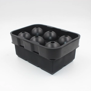 Detail of black silicone mold for making six large spherical ice balls on white background