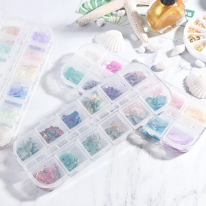 Detailed view of 12-color iridescent nail shell flakes in a clear storage organizer box