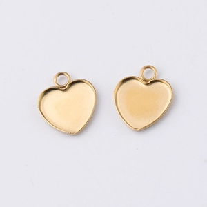 Close-up of gold-plated stainless steel heart-shaped charm settings for DIY jewelry
