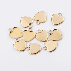 Flat lay of multiple 14mm gold-plated stainless steel heart-shaped charm base trays