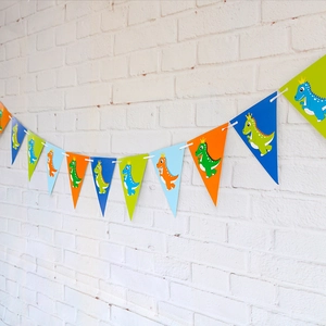 Detailed view of colorful dinosaur themed paper triangle pennant banner for party decor