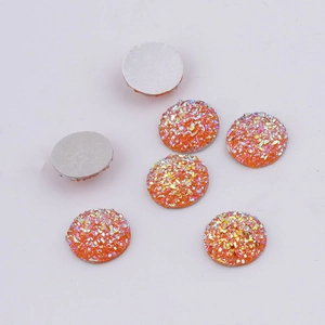 Macro detail of 7 orange round resin drusy stones with flat back for DIY jewelry making