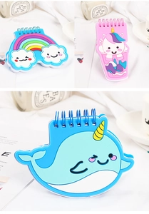 Detail of cartoon rainbow and unicorn shaped mini spiral notebooks with creative PVC covers