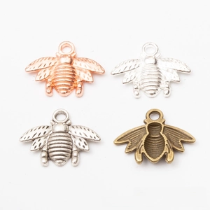 Detail of bee charms in rose gold, bright silver, antique silver, and bronze finishes