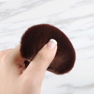 Close-up of soft fluffy bristles of a large makeup brush showing elasticity and density