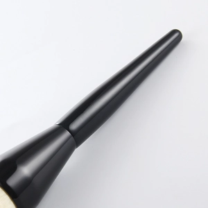 Detail of soft beige bristles and glossy black handle of this large powder makeup brush