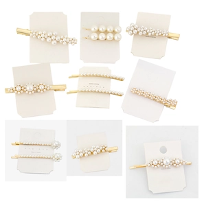 Detailed set of elegant pearl hair clips with gold metal base on display cards