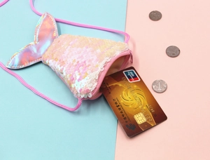 Detail of pink mermaid tail coin purse showing internal storage for coins and cards