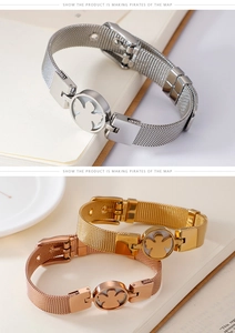 Detail of mesh belt bracelet with hollow angel charm in silver gold and rose gold tones