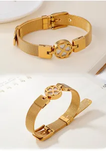 Close-up of golden mesh bracelet featuring a hollow clover charm and adjustable clasp
