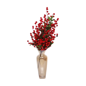 Artificial red berry stems in clear glass vase with green leaves for home decor