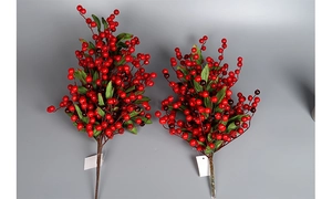 Macro detail of artificial red berry branches with green leaves for holiday decor