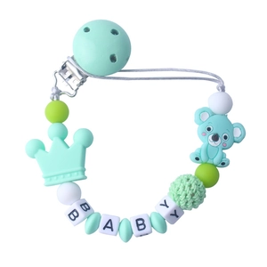 Detail of baby pacifier clip with mint green silicone koala, crown beads and wood clip