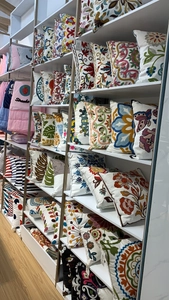 Detailed close-up of colorful floral embroidery and ethnic patterns on cushion covers