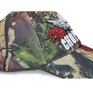 Close-up of premium 3D embroidery on camouflage baseball cap featuring wings and letters