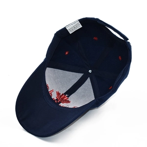 Detail view of acrylic navy blue baseball hat interior with red maple leaf embroidery