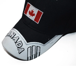 Macro detail of Canada flag embroidery and 3D letters on a black cotton baseball cap