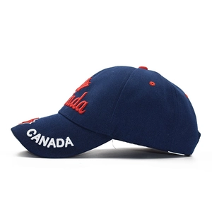 Detailed embroidery of Canada script and red maple leaf on navy cotton baseball cap