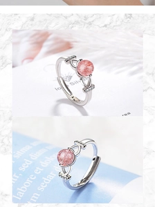 Detailed close-up of natural pink strawberry quartz ring with adjustable silver band