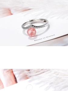 Detail of a wavy silver open ring with pink strawberry crystal and sparkling zircon accents