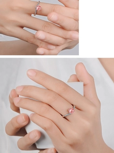 Close-up of model wearing silver ring with pink strawberry crystal and side stones
