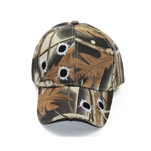 Camouflage baseball cap with embroidered bullet hole patches on cotton fabric