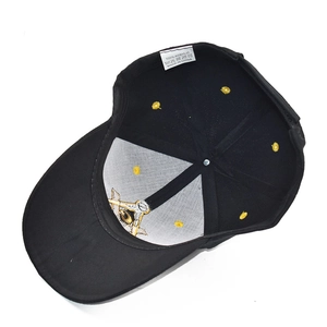 Internal detail of black baseball cap featuring golden Masonic embroidery and acrylic tag