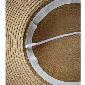 Detailed view of the straw hat interior with sweatband and elastic chin strap