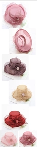 Detail view of foldable organza sun hats with mesh flowers and pearls in multiple colors