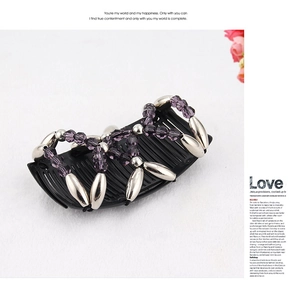 Detail of beaded hair comb with purple beads and silver metal accents on floral background