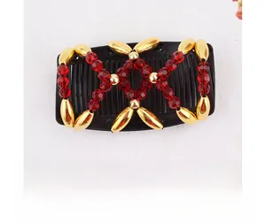 Detail of beaded magic hair comb with red faceted beads and gold metallic accents
