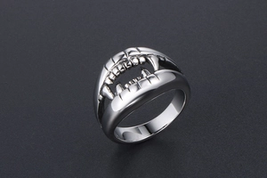 Side view of punk style silver metal crocodile tooth ring with sharp textured details