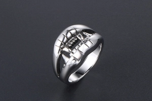 Detailed 45-degree angle of a silver punk crocodile teeth ring with gothic metal texture