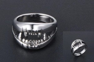 Macro detail of silver punk crocodile tooth ring with sharp polished metallic fangs