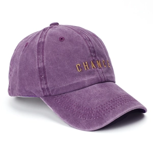 Detailed 45-degree angle view of purple washed cotton baseball cap with gold embroidery