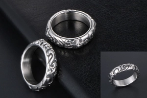 Detailed close-up of retro silver rings featuring star engravings and ornate swirl patterns