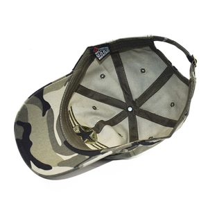 Detail of camouflage cotton cap showing interior stitching, eyelets and metal buckle