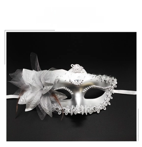 Detail of silver plated Venetian mask with lily floral accents and lace feathers