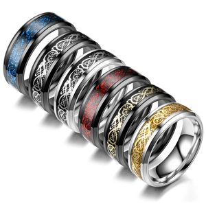 Macro shot of Celtic dragon pattern engravings on multicolored titanium steel fashion rings.