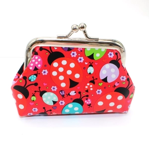 Detail of cute ladybug coin purse featuring a metal kiss-lock clasp and vibrant print