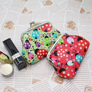Detail of red and green ladybug print mini coin purses with vintage metal clasp closure