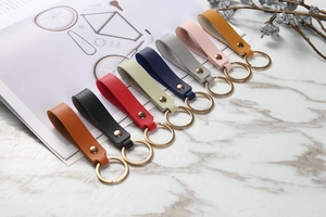 Close-up of multicolored lychee texture leather keychains with golden metal rings