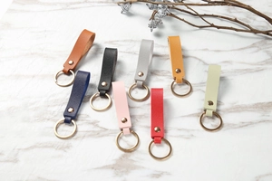 Litchi pattern leather keychains in multiple colors with gold-tone metal hardware