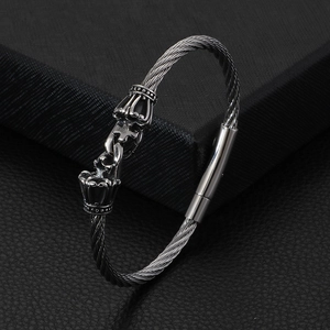 Gothic silver skull cable bracelet featuring twisted steel wire and crown motif accents