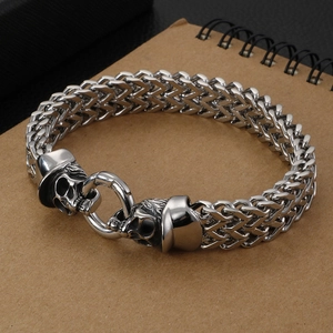 Men's punk stainless steel Franco chain bracelet with skull charm on kraft notebook