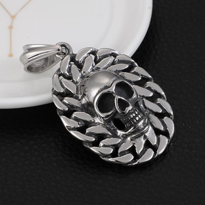 Punk titanium steel skull pendant necklace with cuban chain on black leather background