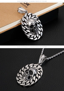 Close-up of a vintage silver skull pendant with braided texture and matching rope chain
