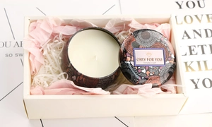 Detail of floral tin soy candle with 'Only For You' lid in a gift box with shredded paper