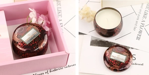 Detail of red vintage tin scented candle presented in an elegant pink gift box set