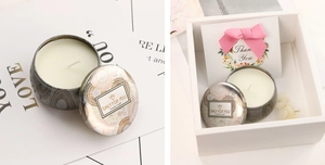 Detailed view of soy candle in gold feather tin with elegant gift box and thank you card